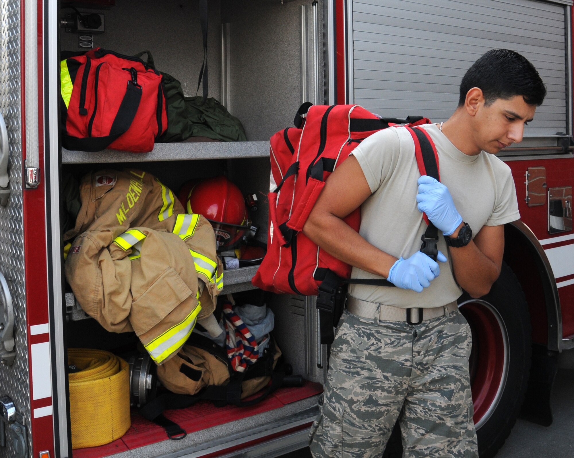 U.S. Air Force Airman 1st Class Jacob Sandoval, 100th Civil Engineer Squadron fire protection journeyman from Pleasanton, Texas, removes a medical bag for inspection as part of the daily equipment checkout Sept. 10, 2014, at the fire department on RAF Mildenhall, England. Firefighters provide basic life support on RAF Mildenhall, then patients are transported to RAF Lakenheath for further treatment if required. (U.S. Air Force photo/Gina Randall/Released)