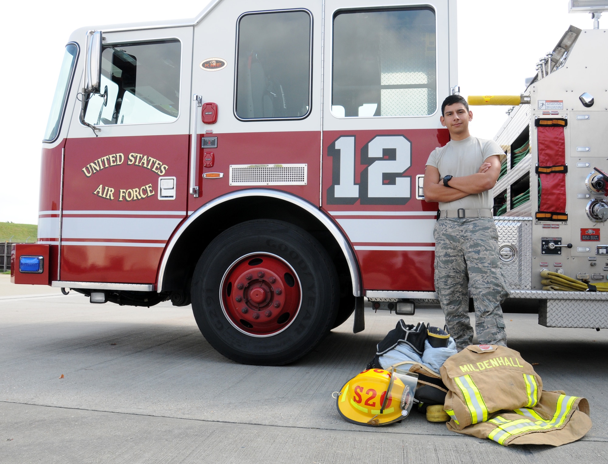 U.S. Air Force Airman 1st Class Jacob Sandoval, 100th Civil Engineer Squadron fire protection journeyman from Pleasanton, Texas, poses in front of a fire truck with his protective equipment Sept. 10, 2014, at the fire department on RAF Mildenhall, England. Sandoval completed one year of service in the Air Force in August 2014. (U.S. Air Force photo/Gina Randall/Released)