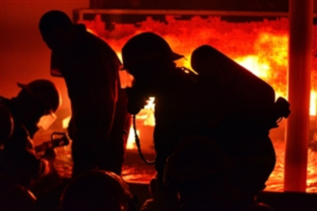 Coast Guardsmen conduct firefighting training in a simulator on the Coast Guard Training Center Cape May, Oct. 16, 2014. 