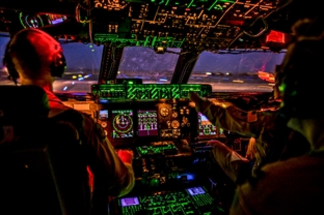 U.S. Air Force Capt. Matthew Upchurch, left, and Capt. Jennifer Nolta take off from Camp Bastion, Afghanistan, Oct. 6, 2014. Upchurch and Nolta are C-5M Super Galaxy pilots assigned to the 9th Airlift Squadron.
