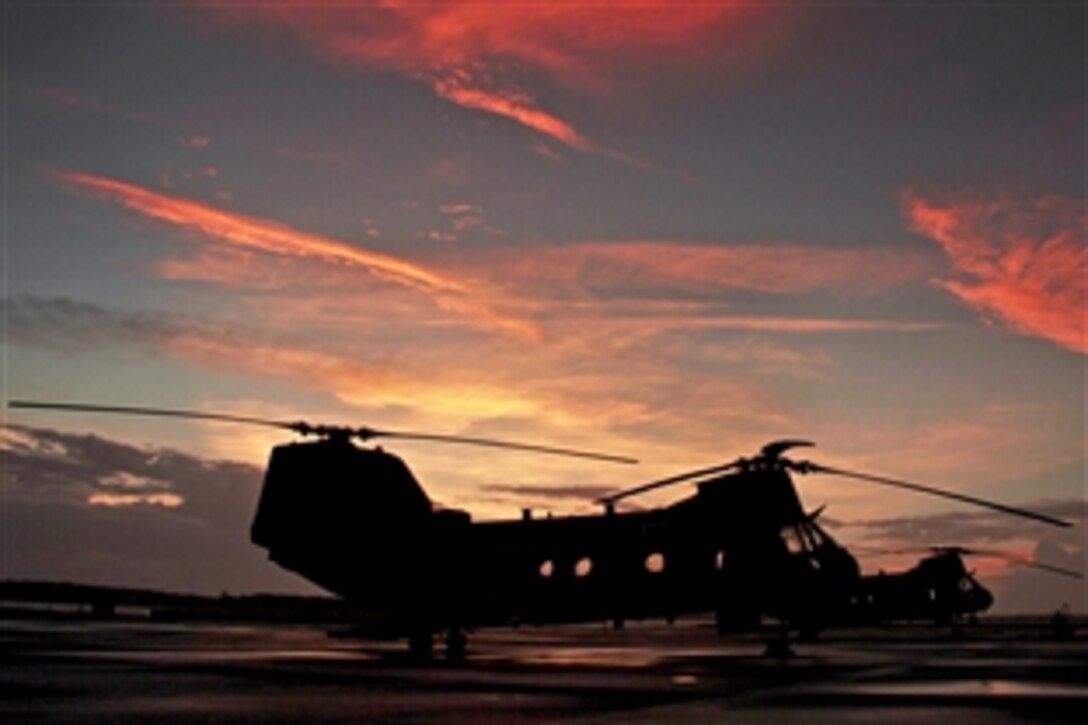 An HH-46E Sea Knight helicopter sits on the flightline as the sun rises on Marine Corps Air Station Cherry Point, N.C., Oct. 14, 2014.
