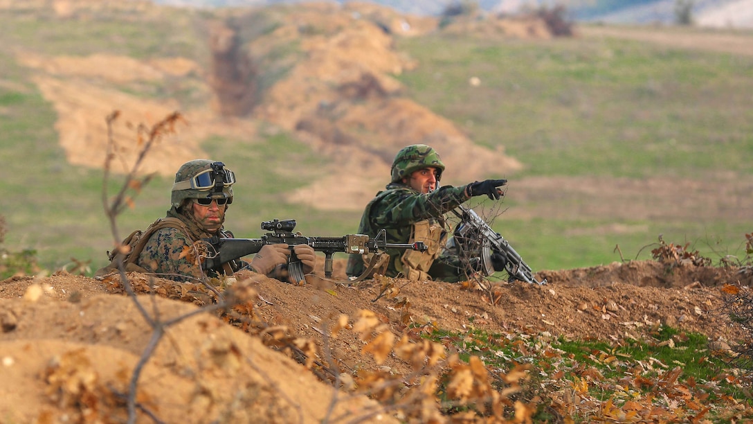 A U.S. Marine and Bulgarian soldier prepare for an enemy attack during Exercise Strike Back, Oct. 15 at the Koren Field Training Ground, Bulgaria. Strike Back is a multilateral combat exercise designed to prepare Bulgarian forces to control, command and operate with joint-nation forces. The training consisted of defensive tactics and offensive objectives and maneuvers.