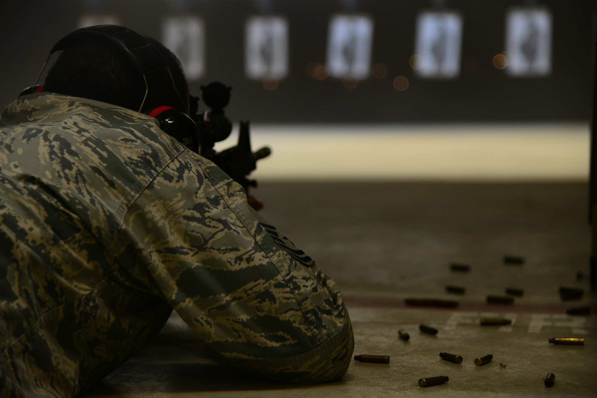 U.S. Air Force Master Sgt. Julimain Patterson, Special Operations Command Central Forward first sergeant, fires an M-4 carbine rifle at Al Udeid Air Base, Qatar. Servicemembers are required to qualify prior to a deployment, and include being able to use the techniques from four stationary positions: lying down with a support, lying down without a support, kneeling with a support and standing behind a barricade. (U.S. Air Force photo by Staff Sgt. Ciara Wymbs)
