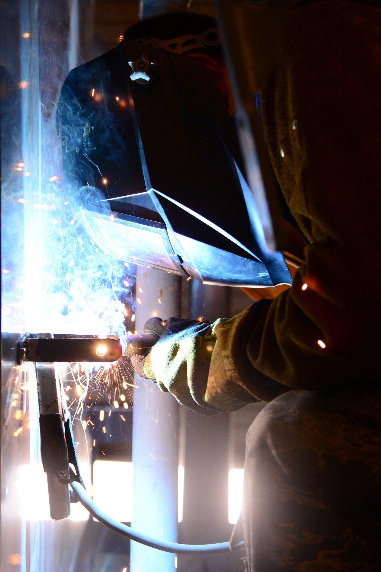 U.S. Air Force Senior Airman Timothy Dahlstrom, 379th Expeditionary Maintenance Squadron aircraft metals technician, welds a bracket at Al Udeid Air Base, Qatar, Oct. 16, 2014. The aircraft metals section at AUAB recently began a new project of designing and building new engine change carts from scrap parts. The cart centralizes tools needed to streamline the process and save time when repairing a propeller or other part of the C-130 Hercules. Dahlstrom is deployed from Dyess Air Force Base, Texas, and hails from Northwest, Iowa. (U.S. Air Force photo by Staff Sgt. Ciara Wymbs)