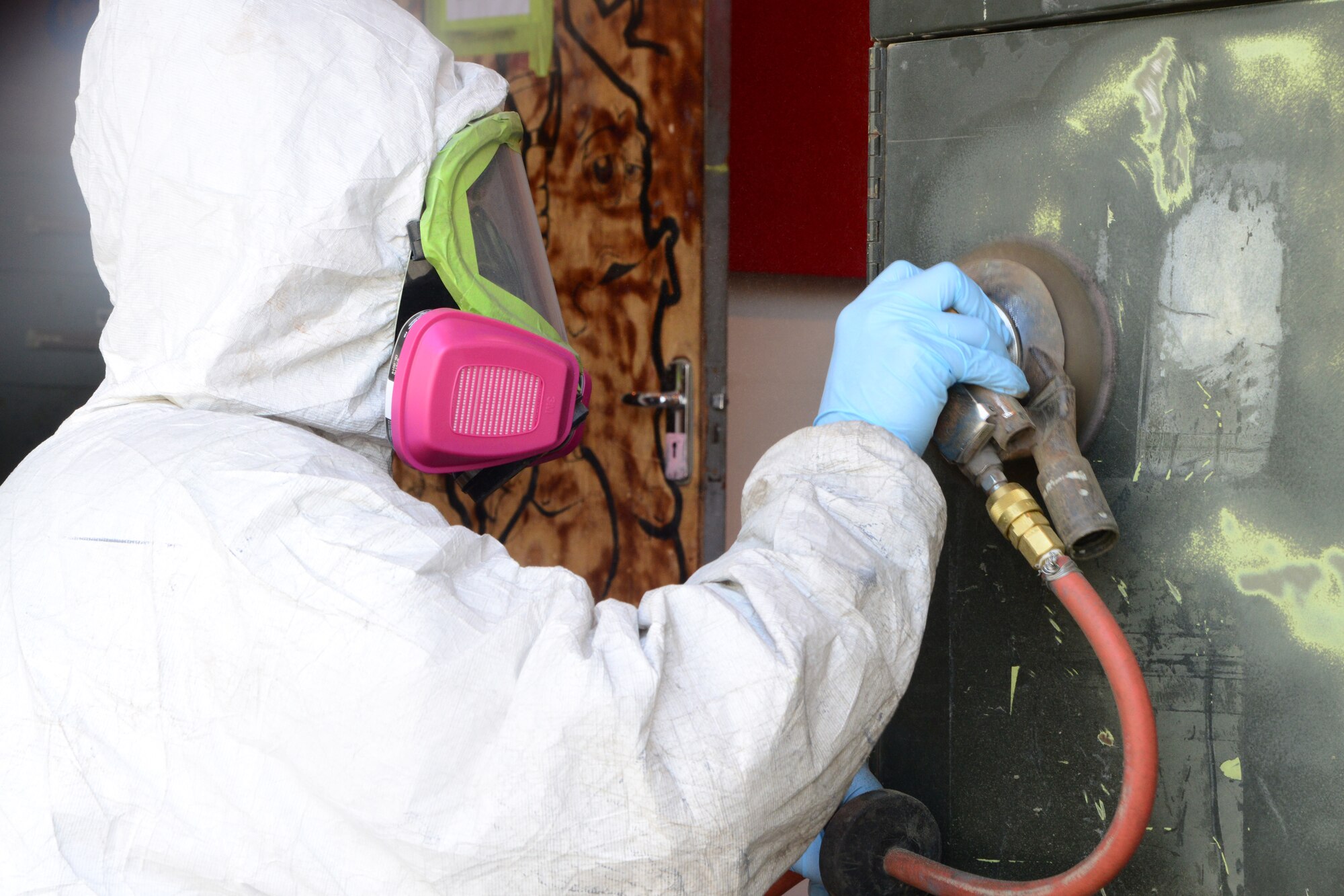 U.S. Air Force Staff Sgt. Christopher Schenkel, 379th Expeditionary Maintenance Squadron aircraft structural maintenance technician, sands an aircraft power generator unit at Al Udeid Air Base, Qatar, Oct. 16, 2014. The unit will become part of a new engine change cart for the 379th EMXS, used for centralizing tools and easing the process to change or repair engine parts on the C-130 Hercules. Schenkel is deployed from Mountain Home Air Force Base, Idaho, and hails from Phoenix. (U.S. Air Force photo by Staff Sgt. Ciara Wymbs)