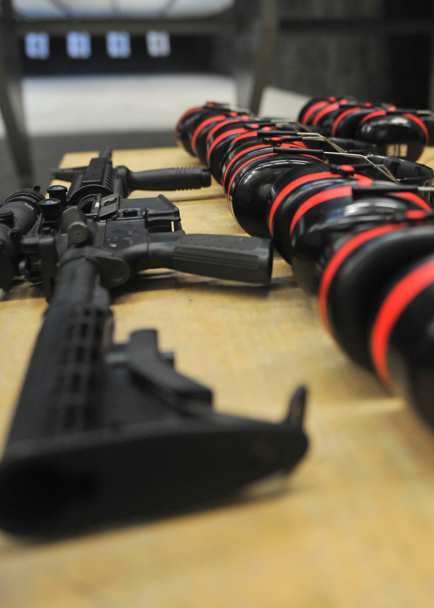 An M-4 carbine rifle and ear protection is used for firing practice at Al Udeid Air Base, Qatar, Oct. 15, 2014. Servicemembers work on fundamentals and techniques of the M-4 carbine rifle during firing practice. (U.S. Air Force photo by Senior Airman Colin Cates)