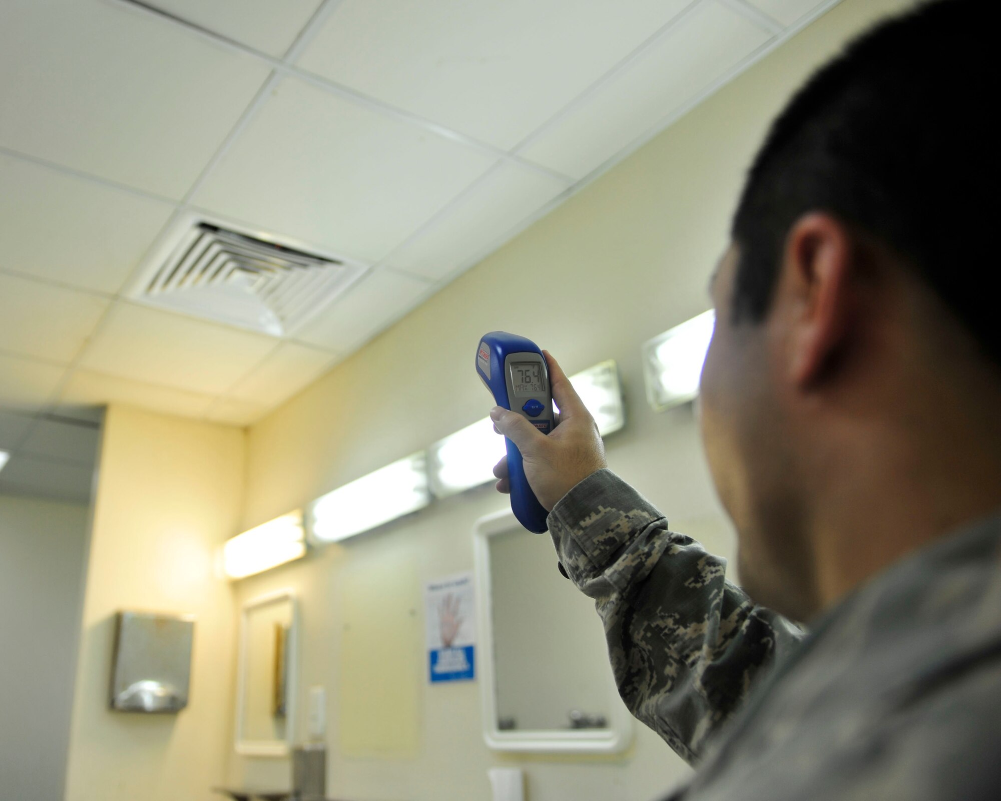 U.S. Air Force Tech. Sgt. Christopher Sakai, 379th Expeditionary Civil Engineer Squadron heating ventilation and air condition asset management planner, uses an infrared Thermometer during a bathroom inspection at Al Udeid Air Base, Qatar, Oct. 9, 2014. Each facility is put into a red, amber or green category, whereby a red rating implies major overhaul, an amber rating implies minor overhaul or cosmetic repairs, and a green rating implies brand new or minor repairs. To execute the short-term repairs, a dedicated four-man team was established and is comprised of an electrician, water fuels system maintenance, heating ventilation and air condition, and structural craftsman. (U.S. Air Force photo by Senior Airman Colin Cates) 
