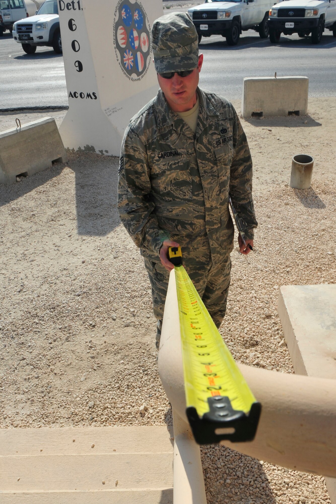 U.S. Air Force Tech. Sgt. Jeffery Cardinal, 379th Expeditionary Civil Engineer Squadron facilities asset management program manager, measures a railing during a bathroom inspection at Al Udeid Air Base, Qatar, Oct. 9, 2014. The emphasis of these repair teams is to identify and execute short-term repairs focusing on facility functionality. (U.S. Air Force photo by Senior Airman Colin Cates) 
