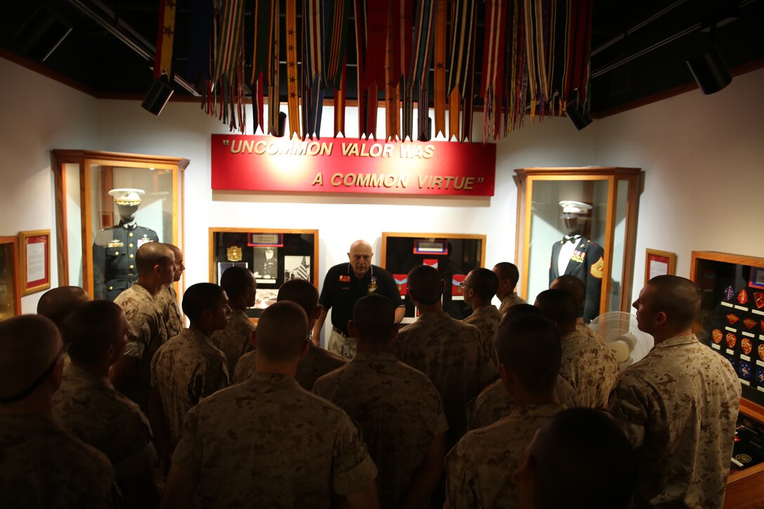 A museum docent explains to the recruits of Bravo Company, 1st Recruit Training Battalion, about the different awards Marines have earned in the Corps during their museum visit at Marine Corps Recruit Depot San Diego, Oct. 7. Once the recruits have earned the title Marine they are allowed to bring their families into the museum and teach them about the history of the Marine Corps.