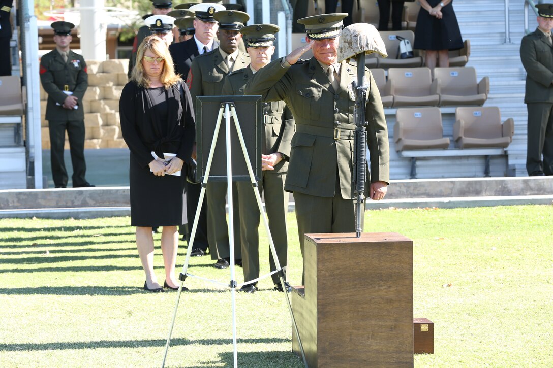 Maj. Gen. Lawrence Nicholson, commanding general, 1st Marine Division, pays his respects by rendering a salute to Sgt. Thomas Spitzer at his memorial ceremony held at Lance Corporal Torrey L. Gray Field, Oct. 14, 2014. After family members went up to the memorial, the rest of the guests got to pay their respects to the fallen Marine.