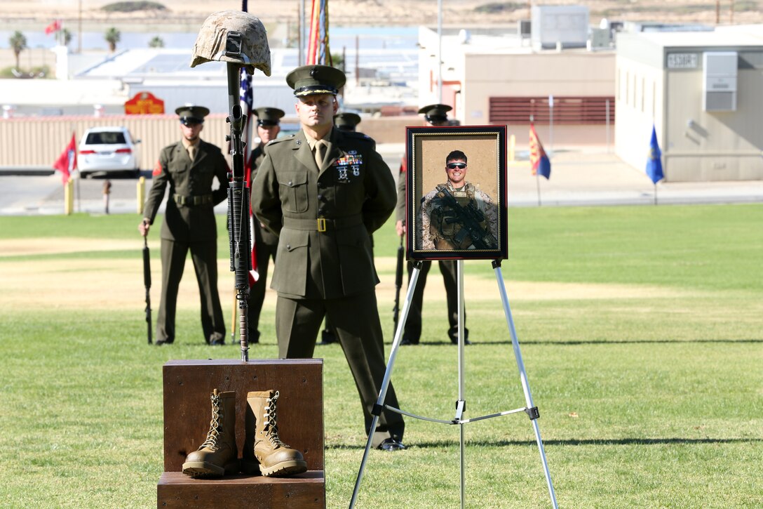 Lt. Col. Seth Yost, battalion commander, 1st Battalion, 7th Marine Regiment, stands at parade rest during the memorial ceremony of Sgt. Thomas Spitzer at Lance Corporal Torrey L. Gray Field, Oct. 14, 2014. Spitzer was a scout sniper for 1/7 who died defending his fellow Marines and sailors in Helmand province, Afghanistan, June 25, 2014.