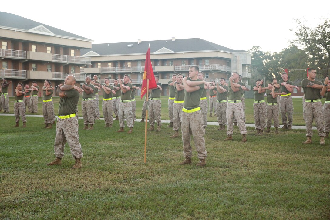 Marines with Battery A, Ground Combat Element Integrated Task Force, conduct cool-down stretches after a three-mile run aboard Marine Corps Base Camp Lejeune, North Carolina, Oct. 17, 2014. From October 2014 to July 2015, the Ground Combat Element Integrated Task Force will conduct individual and collective skills training in designated combat arms occupational specialties in order to facilitate the standards based assessment of the physical performance of Marines in a simulated operating environment performing specific ground combat arms tasks. (U.S. Marine Corps photo by Cpl. Paul S. Martinez/Released)