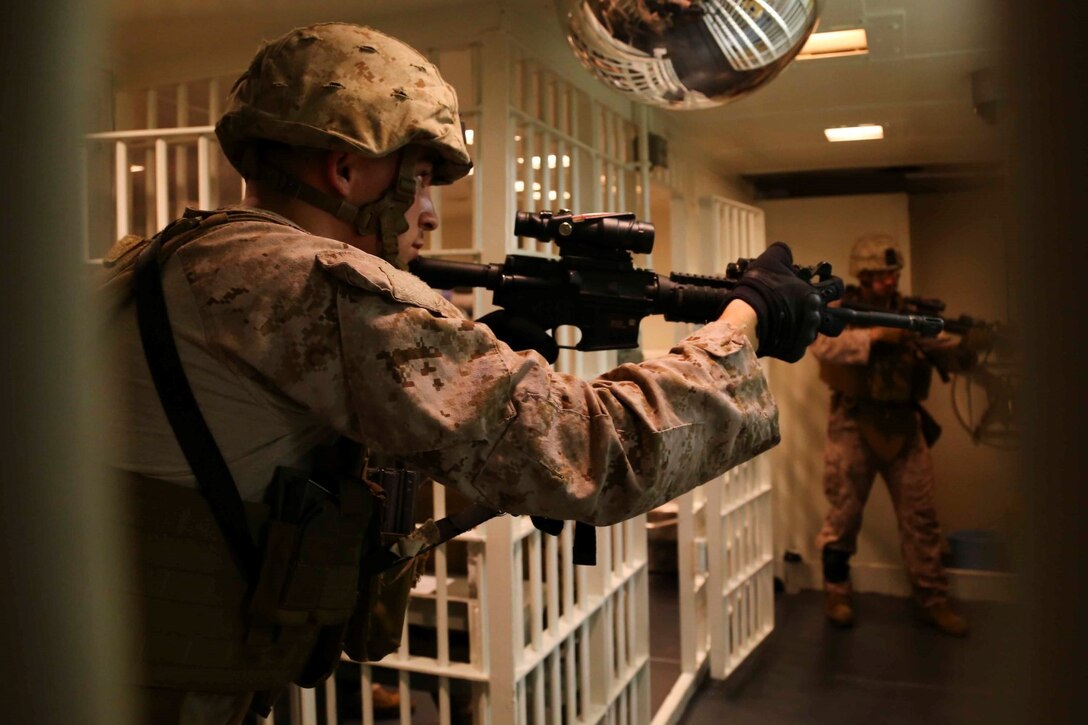 Cpl. Andrew J. Citriniti, a military policeman with the 11th Marine Expeditionary Unit (MEU), and Sauquoit, New York native, practices close quarter tactics aboard the USS Makin Island (LHD 8), Oct. 11.  The Makin Island Amphibious Ready Group (ARG) and the embarked 11th MEU are deployed in support of maritime security operations and theater security cooperation efforts in the U.S. 5th Fleet area of responsibility. (U.S. Marine Corps photo by Cpl. Laura Y. Raga/ RELEASED)

