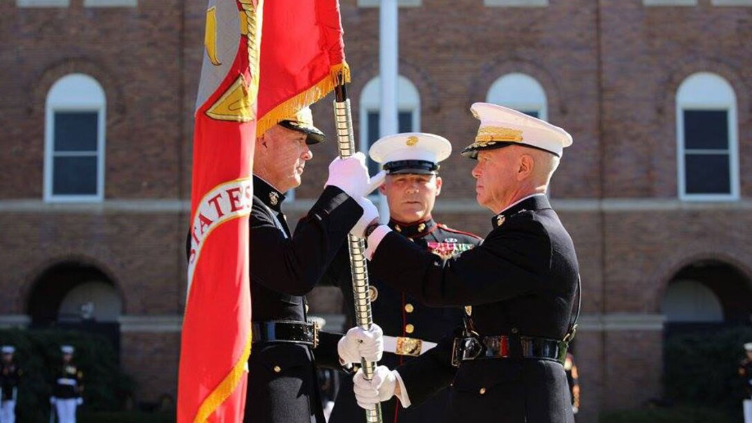 Washington, District of Columbia - Gen. James F. Amos, the 35th Commandant of the Marine Corps, passes the colors to Gen. Joseph F. Dunford, Jr., during the change of command and subsequent retirement ceremony Oct. 17, 2014 at Marine Corps Barracks Washington, at 8th & I. After more than 44 years of military service, Amos passed the duties as senior-ranking officer of the Marine Corps to Dunford, who has now become the 36th Commandant of the Marine Corps. 
