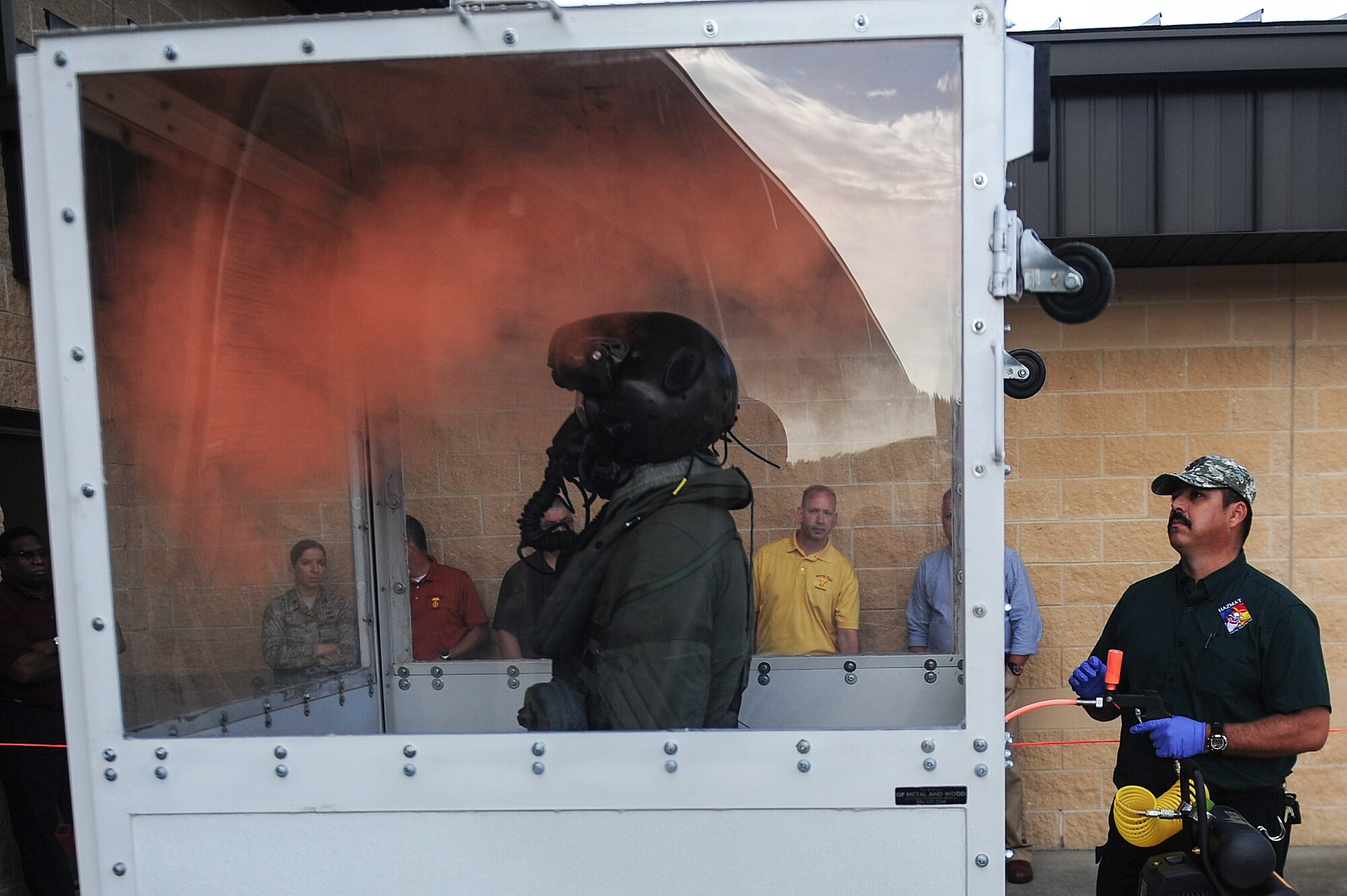 Airman 1st Class Kyle Rogers, left, an Aircrew Flight Equipment specialist assigned to the 355th Operations Support Squadron at Davis-Monthan Air Force Base, Ariz., is sprayed with a chemical agent by Miguel Vigil, an employee of Hazmat Training Consulting LLC, during an Air Combat Command Joint Aircrew Flight Equipment evaluation testing Oct. 14, 2014, at Seymour Johnson Air Force Base, N.C. Representatives from several bases were on hand to test current and future flight equipment for every aircraft in the Air Force inventory, including the newest fighter, the military's F-35 Lightning II. (U.S. Air Force photo/Airman 1st Class Brittain Crolley)