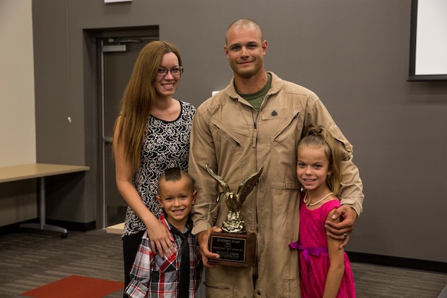 U.S. Marine Sgt. Guy Higgins poses with his family after receiving the Navy and Marine Corps Association Leadership Award Sept. 26, 2014. Higgins, 27, is from Mattoon, Illinois, and is a sniper with the Force Reconnaissance Detachment, 15th Marine Expeditionary Unit.  (U.S. Marine photo by Cpl. Anna Albrecht/Released)