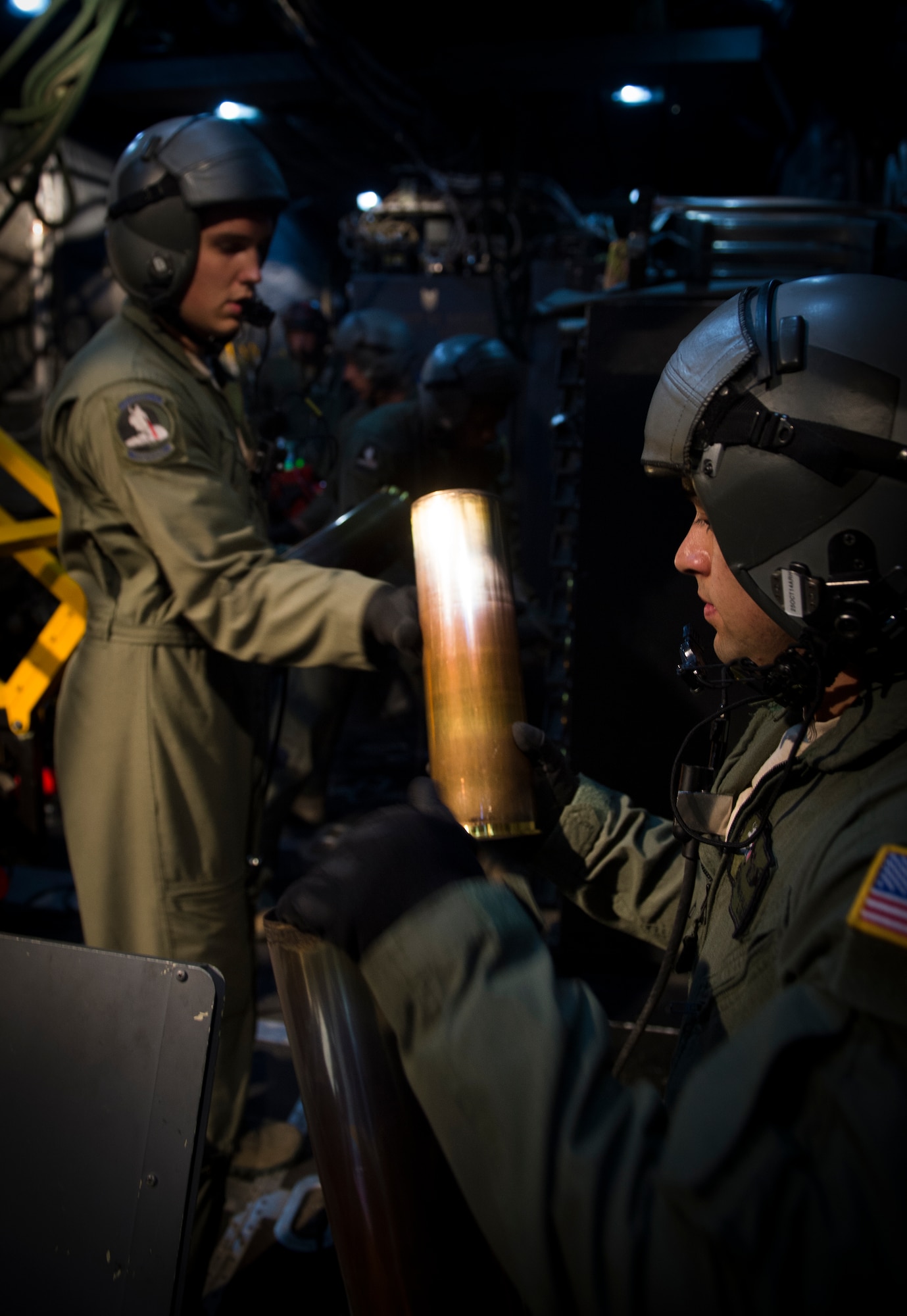 Aerial gunners from the 4th Special Operations Squadron assist each other in racking the empty 105mm shells after a training mission on board an AC-130U Spooky Gunship, Oct. 15, 2014. The crew participated in a one-minute drill, which consisted of firing off nine rounds in one minute. (U.S. Air Force photo/Senior Airman Christopher Callaway) 