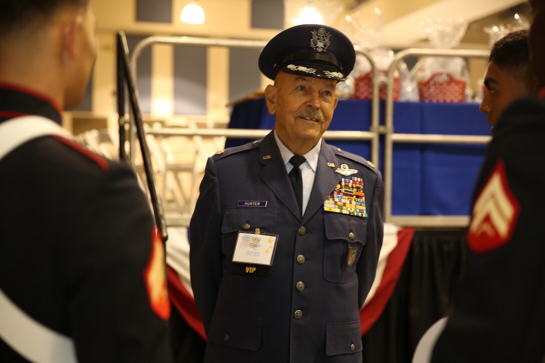 (ret.)Lt. Col. Dean Hunter, honoree, talks to Combat Center Marine color guard at the 5th Annual Veterans Expo at the Riverside County Fairground in Indio, Calif., Oct. 11, 2014. Hunter spent six years in the Marine Corps as a rifleman before moving to the Air Force to become a pilot. His personal awards include the Silver Star, Distinguished Air Service Medal with V device for valor and more than seven air warfare ribbons.