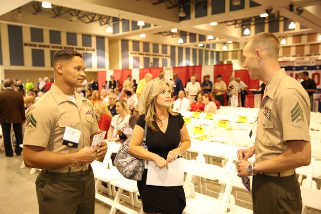 Sgt. Douglas Lockard, platoon sergeant, Combat Logistics Battalion 7, and Cpl. Daniel Kinney, ground radio technician, CLB-7, talk to Jennifer Daniels, anchor, CBS Channel 2, during the 5th Annual Veterans Expo at the Riverside County Fairgrounds in Indio, Calif., Oct. 11, 2014. Jennifer Daniels and Tom Tucker, CBS Channel 2 News anchors, were the Masters of Ceremonies.