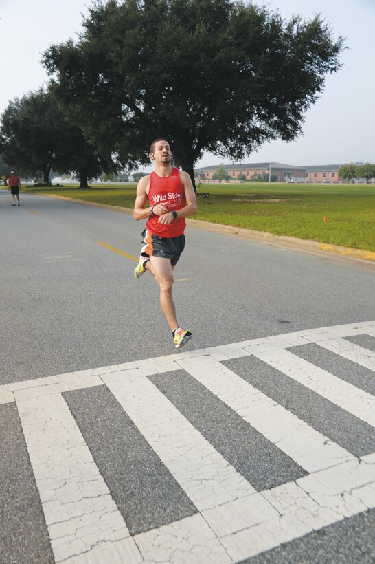 Arnoldo DeJesus races across the finish line as the 5K overall winner during the second annual Run for Wounded Heroes event Saturday, aboard Marine Corps Logistics Base Albany. Sponsored by several local area businesses, the event also featured a 10K and 1-mile fun run.