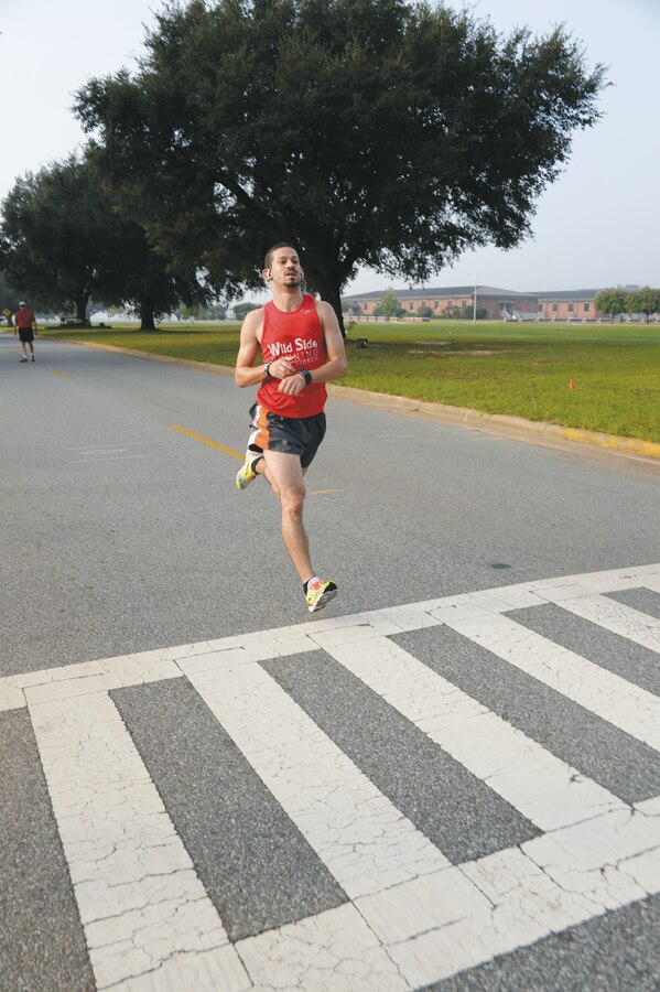 Arnoldo DeJesus races across the finish line as the 5K overall winner during the second annual Run for Wounded Heroes event Saturday, aboard Marine Corps Logistics Base Albany. Sponsored by several local area businesses, the event also featured a 10K and 1-mile fun run.
