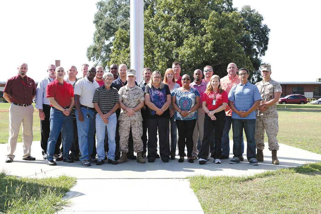 Ground Mishap Investigation class attendees gather for a group photo in front of the flagpole located at Building 3700, Marine Corps Logistics Command, recently.