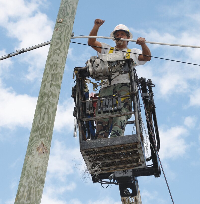 Carl Fox, foreman/contractor, Bigham Construction, Inc., ties in new fiber optic cable into existing overhead wiring at Marine Corps Logistics Base Albany, recently. Fox, a Mediacom contractor, is part of a three-man crew contracted to complete the project.