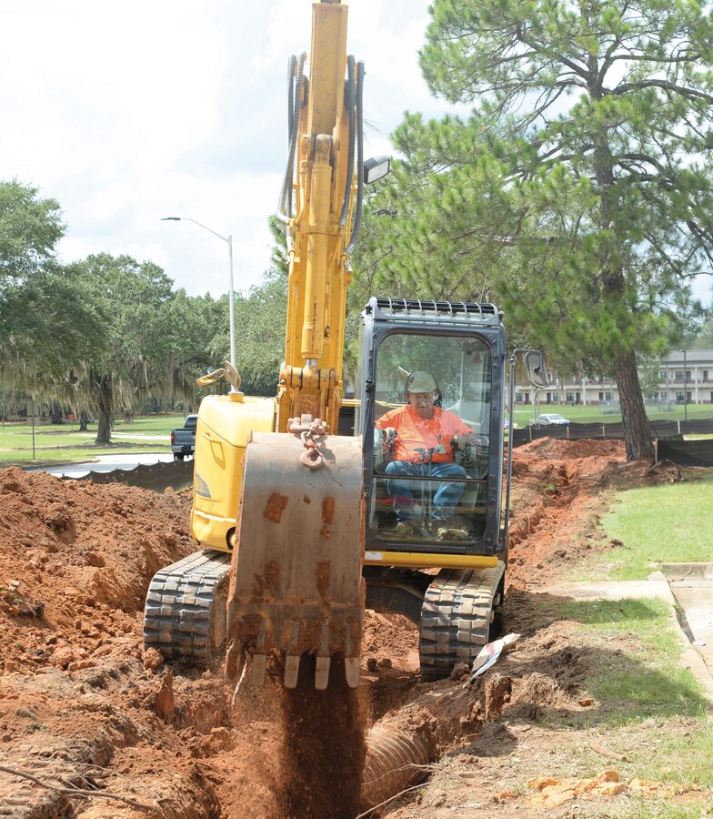 Bill Harris, contractor/project supervisor, Tybe Company, Newbern, Tenn., covers underground water pipes at Marine Corps Logistics Base Albany, recently.