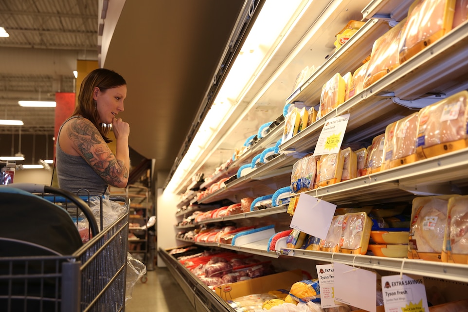 Marcie Garcia, tour participant, chooses the health food during a Cooking Matters Tour at the commissary, Oct. 9, 2014.