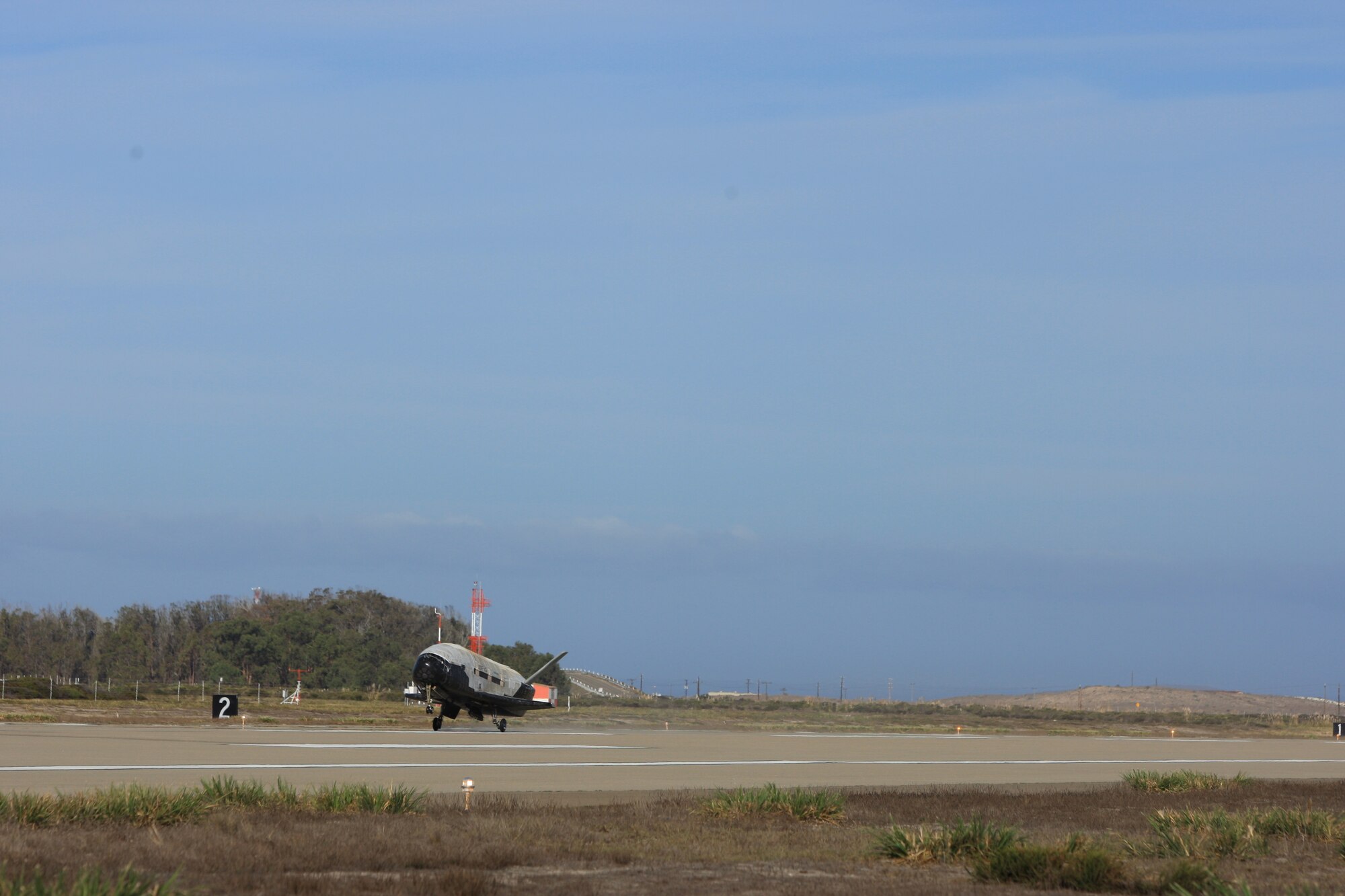The X-37B Orbital Test Vehicle mission 3 (OTV-3), the Air Force's unmanned, reusable space plane, landed at Vandenberg Air Force Base at 9:24 a.m. Oct. 17, 2014. The OTV-3 conducted on-orbit experiments for 674 days during its mission, extending the total number of days spent on-orbit for the OTV program to 1367 days. The X-37B is the newest and most advanced re-entry spacecraft. Managed by the Air Force Rapid Capabilities Office, the X-37B program performs risk reduction, experimentation and concept of operations development for reusable space vehicle technologies. (Photo credit: Boeing)
