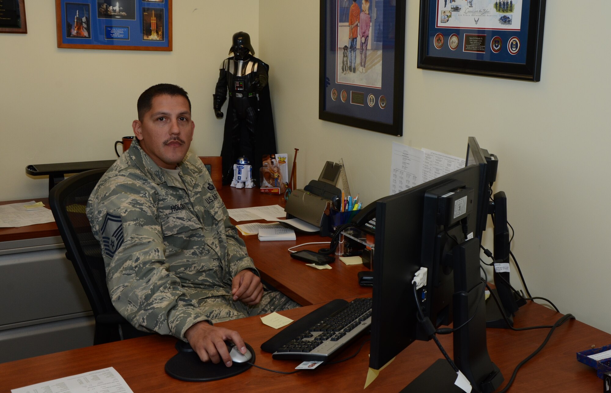 Senior Master Sgt. Jasen Holguin, personnel superintendent with the 624th Regional Support Group, looks up from his desk at Joint Base Pearl Harbor-Hickam, Hawaii, Oct. 17, 2014. Due to the unexpected cancellation of the 624th RSG's October unit training assembly here at Hickam Field, Hawaii, he said unit members who have not recertified their Basic Allowance for Housing (BAH) would need to do so by the November UTA in order to meet the December deadline. (U.S. Air Force photo by Tech. Sgt. Phyllis Keith)