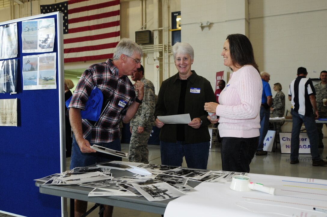 North Carolina Air National Guard retirees, Kris Transon, (left) Sherry Hamrich, (center) and Kathy Groce, (right) reminisce and catch up as they look over old photos during the 19th Annual Retiree Breakfast. This annual tradition, held at the North Carolina Air National Guard base, Charlotte Douglas Intl. Airport, October 3, 2014, is hosted by the 145th Airlift Wing’s Chiefs’ Council to honor the men and women who have retired after serving in the North Carolina Air National Guard. (U.S. Air National Guard photos by Master Sgt. Patricia F. Moran, 145th Public Affairs/Released)