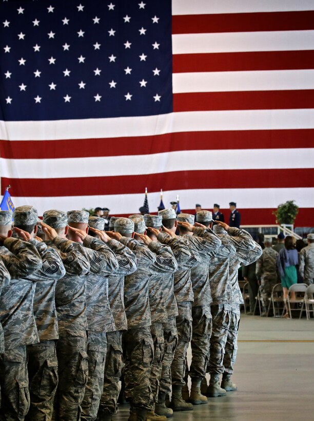 Members of the 932nd Airlift Wing respond to the verbal command "present arms", the command for saluting and giving attention to the flag, during a change of command ceremony Sept. 14, 2014 at Hanger 1, Scott Air Force Base Ill.  (U.S. Air Force photo/Tech. Sgt. Christopher Parr)