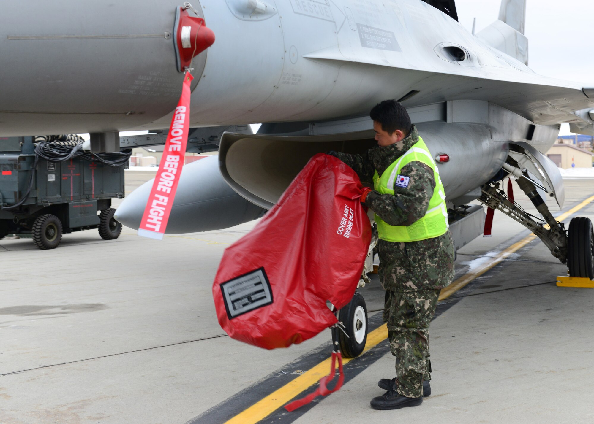 Republic of Korea air force Master Sgt. Soo Young Chae, a crew chief assigned to the 120th Aircraft Maintenance Flight, prepares a KF-16D Fighting Falcon fighter aircraft for a sortie at Eielson Air Force Base, Alaska, Oct. 15, 2014, during RED FLAG-Alaska 15-1. RF-A is a series of Pacific Air Forces commander-directed field training exercises for U.S. and partner nation forces, providing combined offensive counter-air, interdiction, close air support and large force employment training in a simulated combat environment. (U.S. Air Force photo by Senior Airman Ashley Nicole Taylor/Released)
