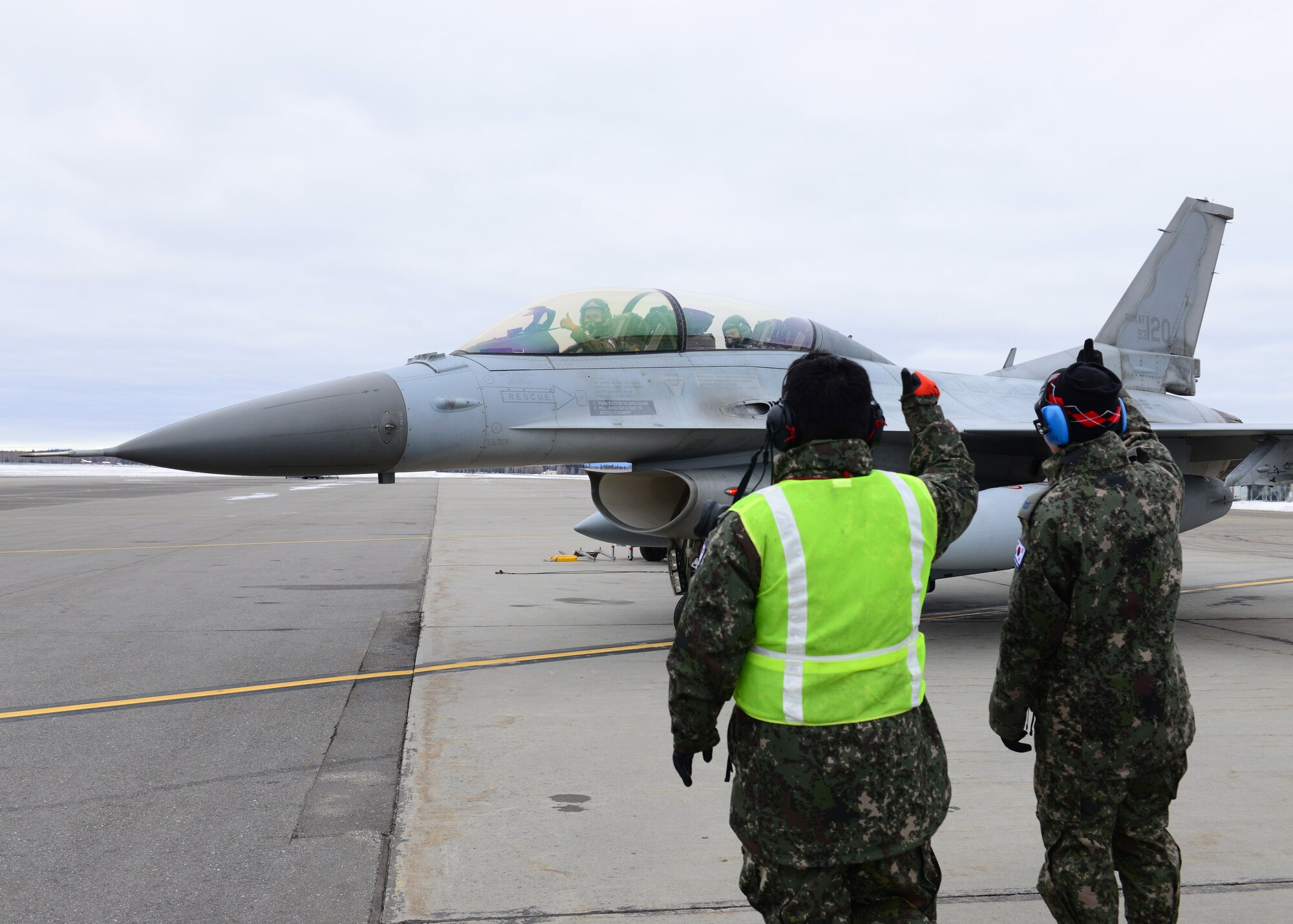 Republic of Korea air force maintainers and pilots wave goodbye to each other before a sortie at Eielson Air Force Base, Alaska Oct. 15, 2014, during RED FLAG-Alaska 15-1. RF-A is a series of Pacific Air Forces commander-directed field training exercises for U.S. and partner nation forces, providing combined offensive counter-air, interdiction, close air support and large force employment training in a simulated combat environment. (U.S. Air Force photo by Senior Airman Ashley Nicole Taylor/Released)
