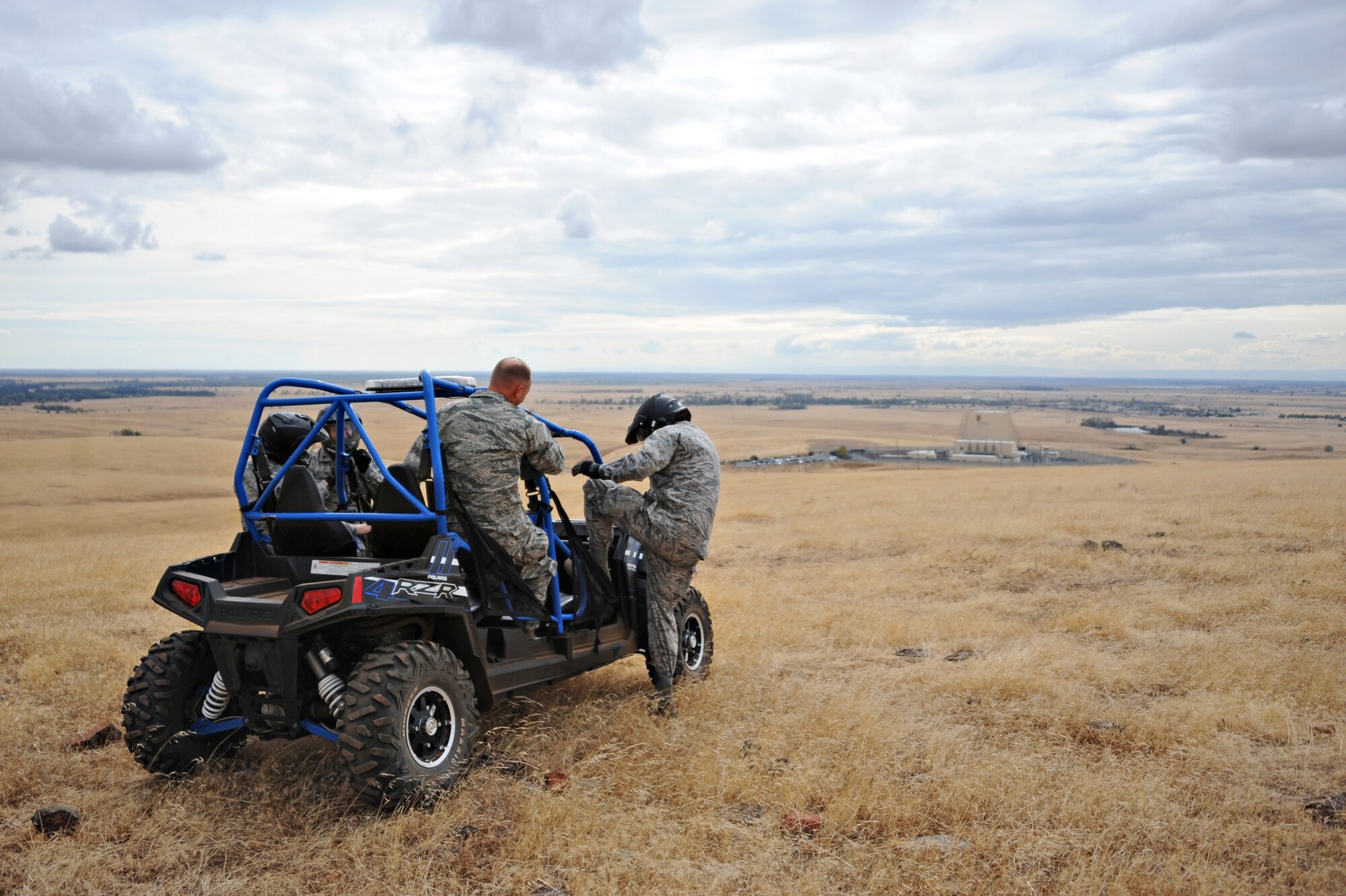 Maj. Gen. John Shanahan, 25th Air Force commander, exits an all-terrain vehicle on top of a hill to view the entire installation during his visit to the 9th Reconnaissance Wing at Beale Air Force Base, Calif., Oct. 15, 2014. Shanahan also rode along of the perimeter of the base with members of the 9th Security Forces Squadron. (U.S. Air Force photo by Airman 1st Class Ramon A. Adelan/Released)
