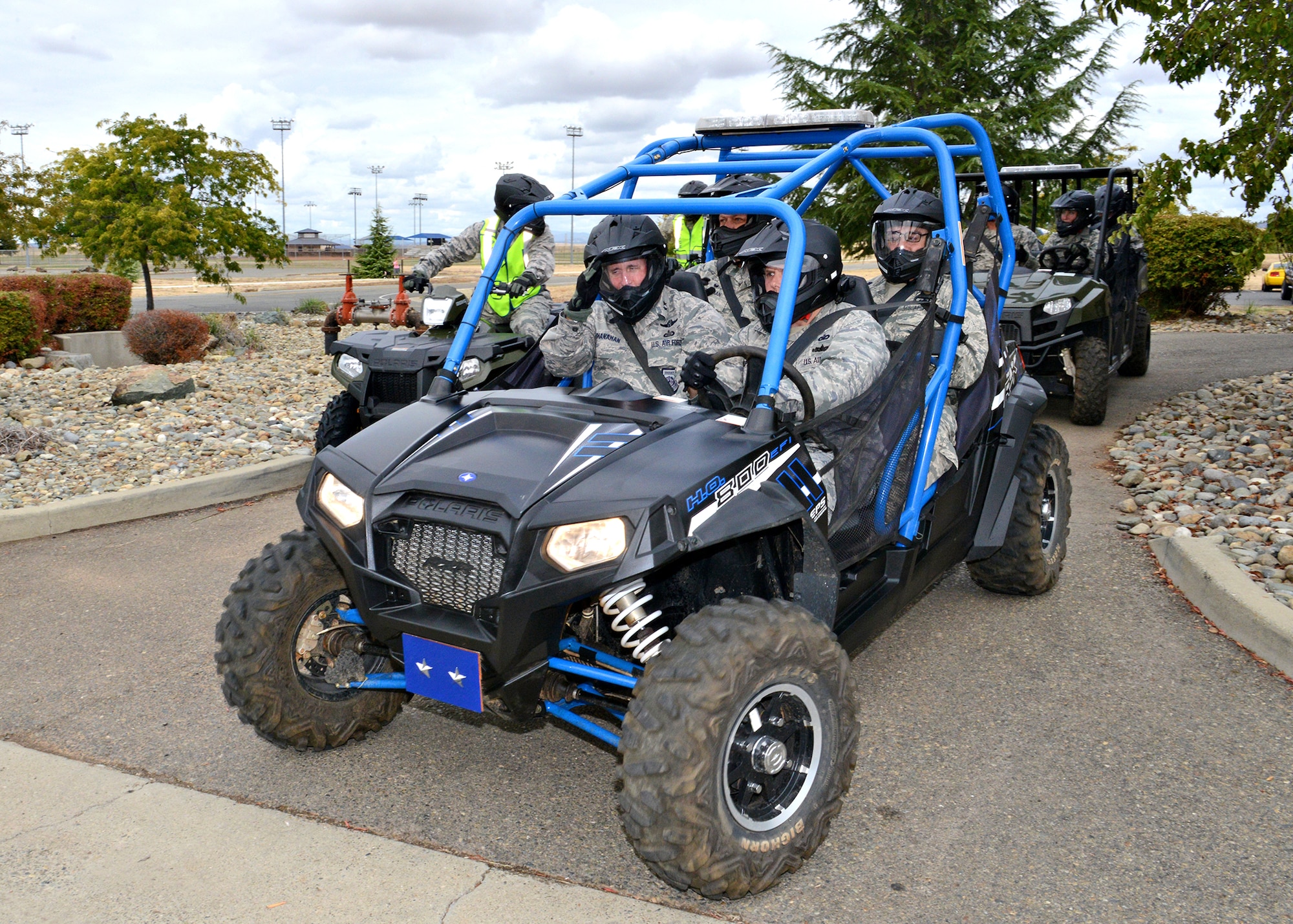 Maj. Gen. John Shanahan, 25th Air Force commander, and Chief Master Sgt. Roger Towberman, 25th AF command chief, ride on an all-terrain vehicle with members from the 9th Security Forces Squadron around the perimeter of Beale Air Force Base, Calif., Oct. 15, 2014.  Shanahan and Towberman visited Beale for the first time since the Sept. 29 re-alignment of the 9th Reconnaissance Wing to the 25th AF. (U.S Air Force photo by John Schwab/Released)