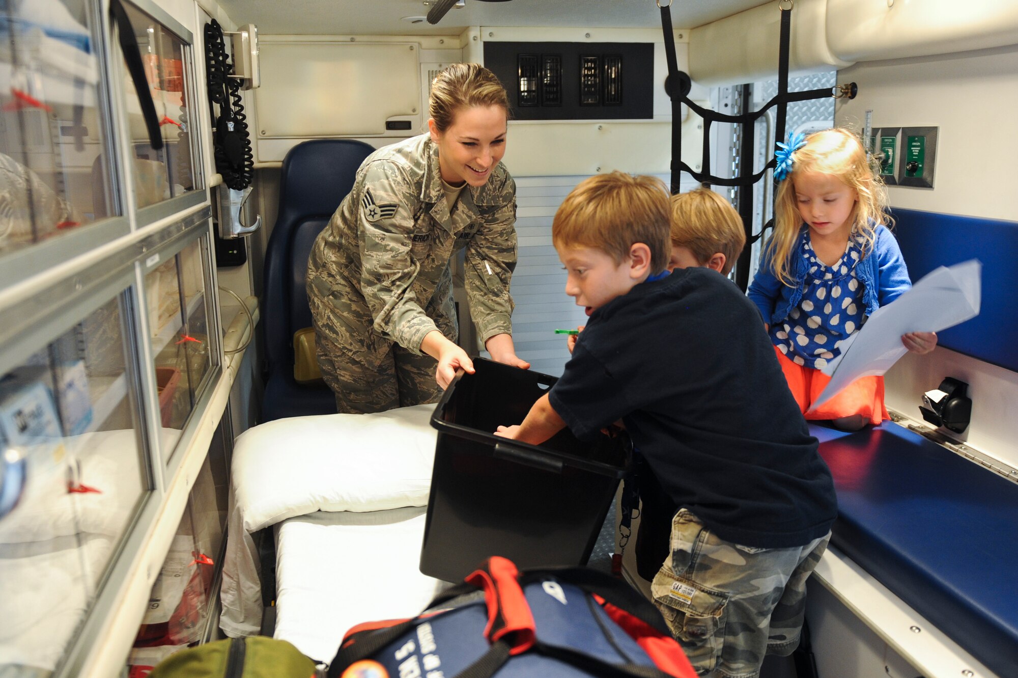Senior Airman Nichole Sommerich, 4th Aerospace Medicine Squadron medical technician, displays medical equipment in the back of an ambulance for children participating in the Airman and Family Readiness Center’s Operation Bug Out at Seymour Johnson Air Force Base, North Carolina, Oct. 15. In order to help the children of Seymour Johnson AFB understand what their parents do to prepare for real-world deployments, children between the ages of five and 15 participated in a mock deployment. The event mirrored the events of an actual deployment including briefings, processing through a personnel deployment function line and transporting their equipment to an awaiting military aircraft. (U.S. Air Force photo/Airman 1st Class Aaron Jenne)
