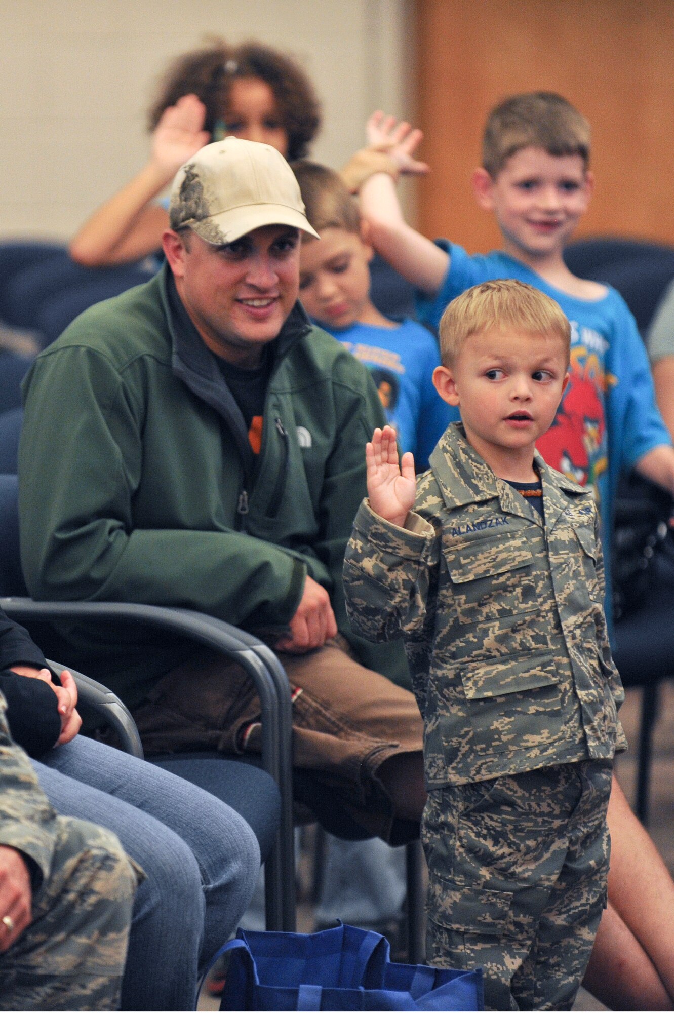 One of Team Seymour’s youngest members takes a simulated oath of enlistment before deploying in support of the Airman and Family Readiness Center’s Operation Bug Out at Seymour Johnson Air Force Base, North Carolina, Oct. 15. In order to help the children of Seymour Johnson AFB understand what their parents do to prepare for real-world deployments, children between the ages of five and 15 participated in a mock deployment. The event mirrored the events of an actual deployment including briefings, processing through a personnel deployment function line and transporting their equipment to an awaiting military aircraft. (U.S. Air Force photo/Airman 1st Class Aaron Jenne)
