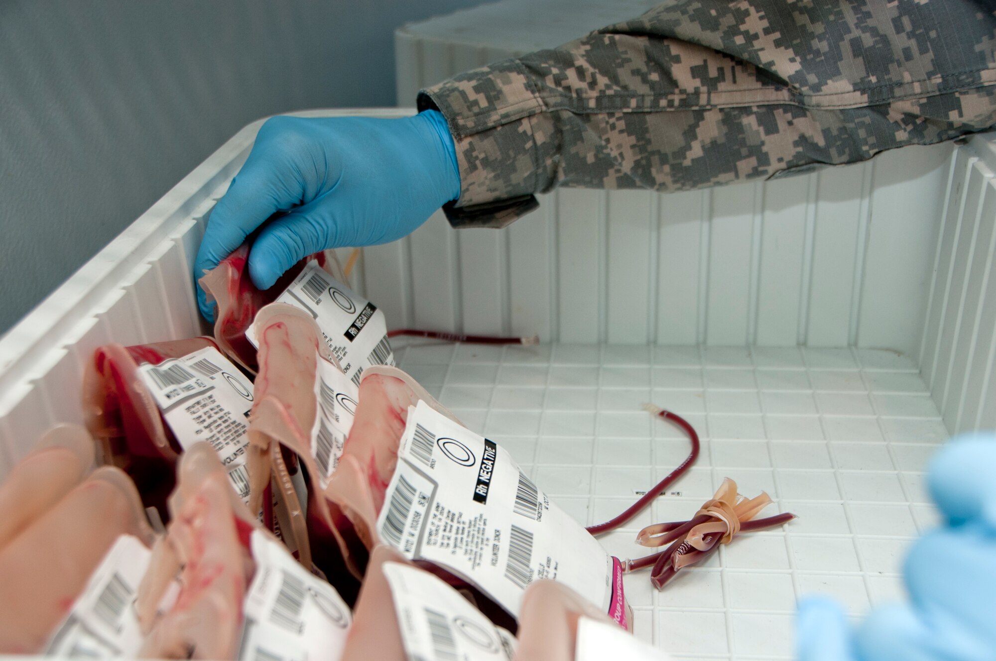 Army Sgt. Dusty Edwards, 60th Medical Group laboratory technician, sorts through different units of blood Sept. 18, 2014, ensuring the correct units are ready to be shipped out. (U.S. Air Force photo by Senior Airman Charles Rivezzo)