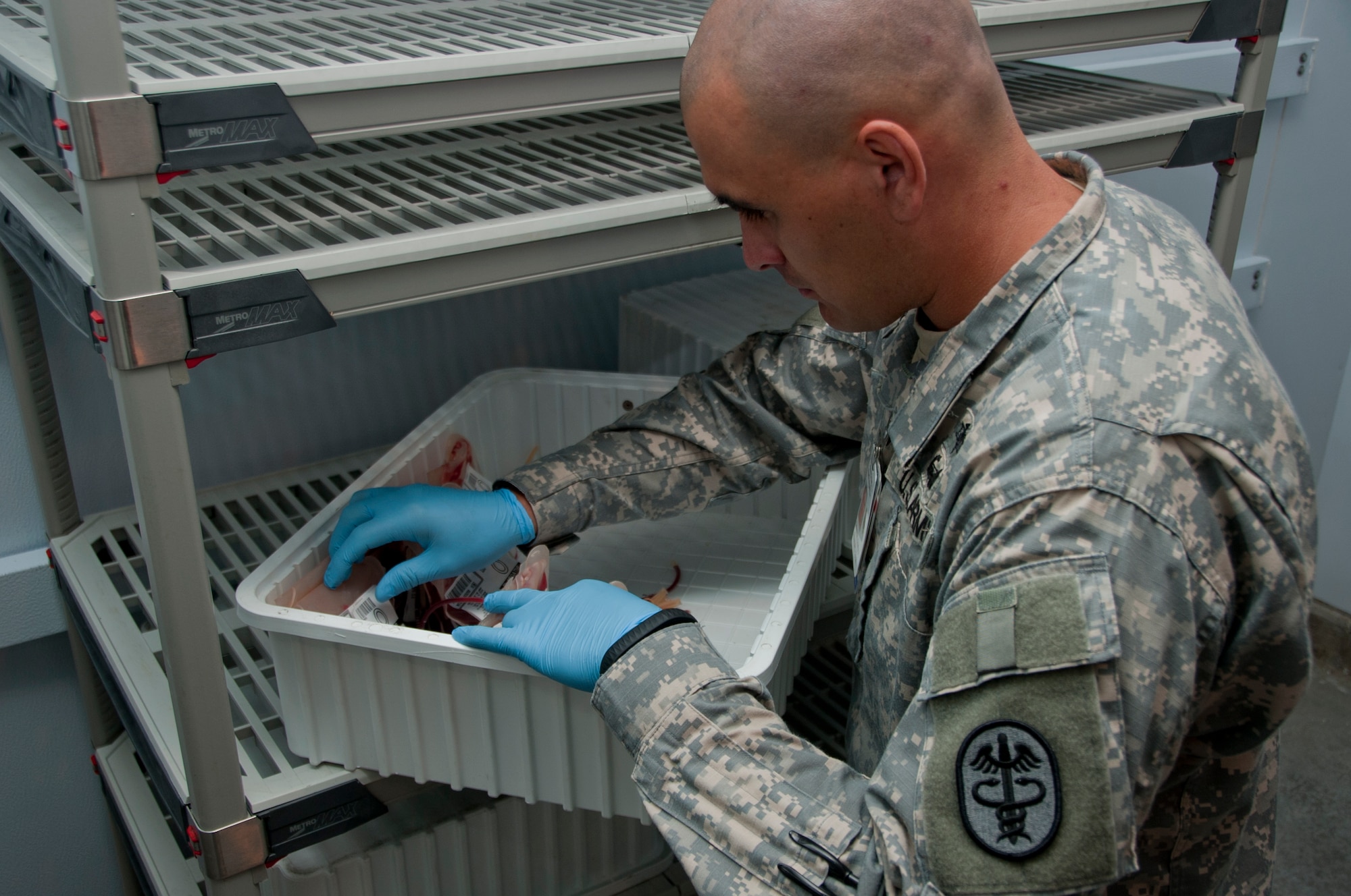 Army Sgt. Dusty Edwards sorts through different units of blood Sept. 18, 2014, ensuring the correct units are ready to be shipped out. Edwards serves as a laboratory technician at the Armed Forces Whole Blood Processing Laboratory West on Travis Air Force Base, California. The center is manned by Airmen, Sailors, Soldiers and civilians, and has been a joint operation since the Department of Defense created the mission for the Armed Services Blood Program in 1966. (U.S. Air Force photo by Senior Airman Charles Rivezzo)