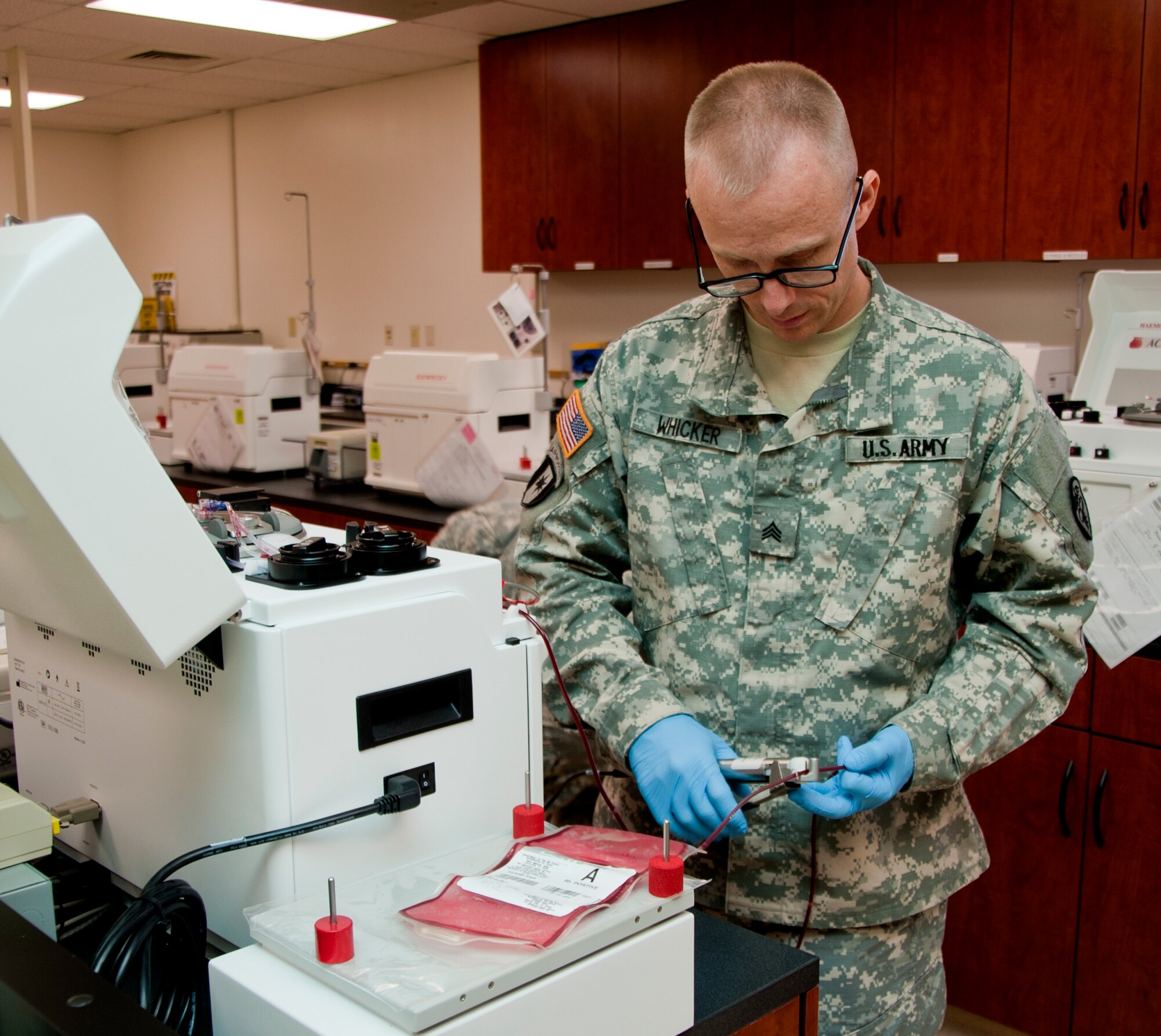 Army Sgt. Jered Whicker, 60th Medical Group laboratory technician, clamps down on medical tubing Sept. 18, 2014. Throughout his career, Whicker has served in multiple austere locations around the world, including a 14-month deployment to Iraq as a laboratory technician. (U.S. Air Force photo by Senior Airman Charles Rivezzo)