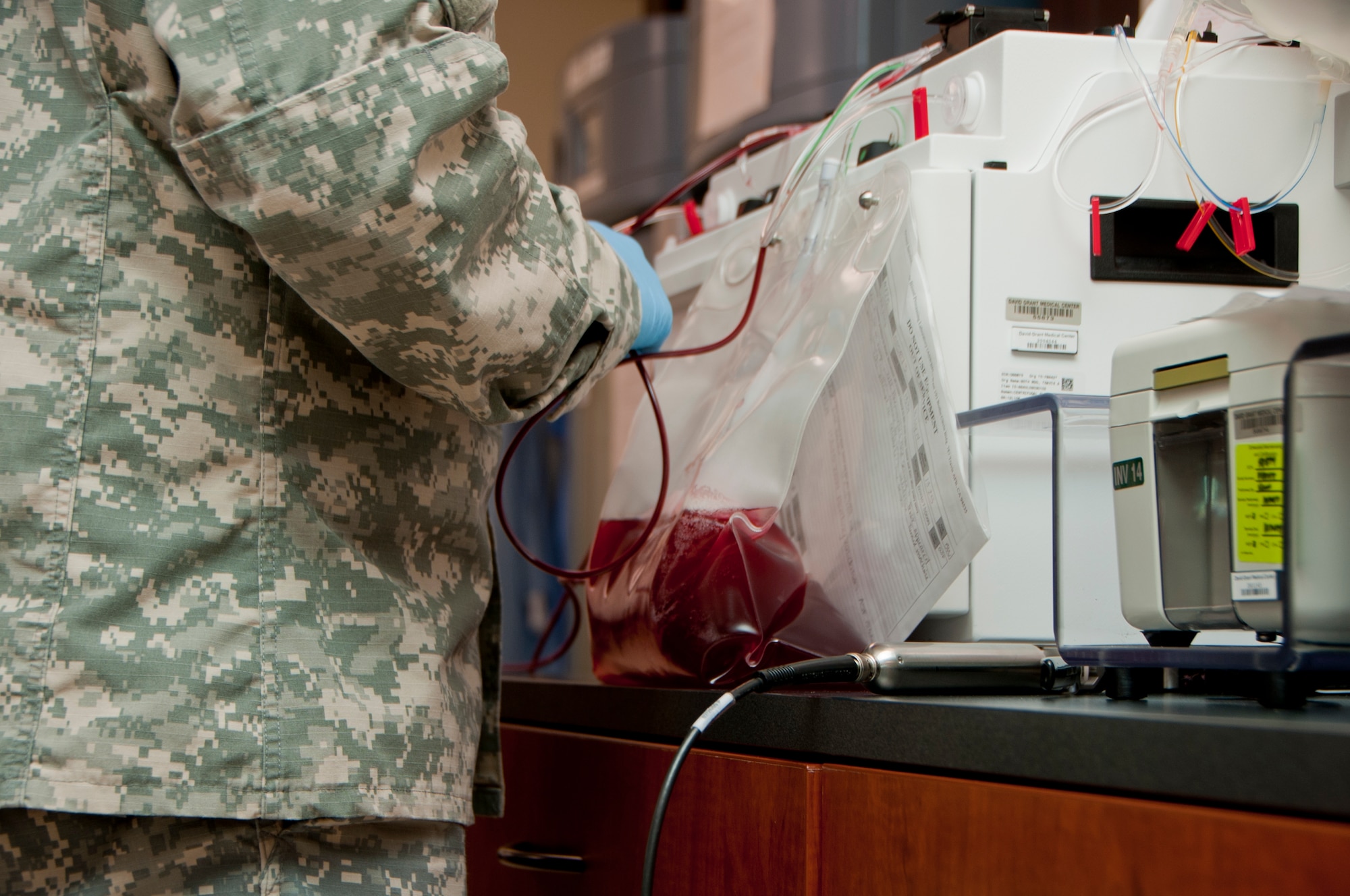 Army Sgt. Jered Whicker, 60th Medical Group laboratory technician, utilizes a piece of equipment that processes blood units Sept. 18, 2014, at the Armed Forces Whole Blood Processing Laboratory West on Travis Air Force Base, California. AFWBSL-West is one of only two facilities in the entire Department of Defense that specializes in consolidating, processing and shipping blood to labs across the globe. (U.S. Air Force photo by Senior Airman Charles Rivezzo)
