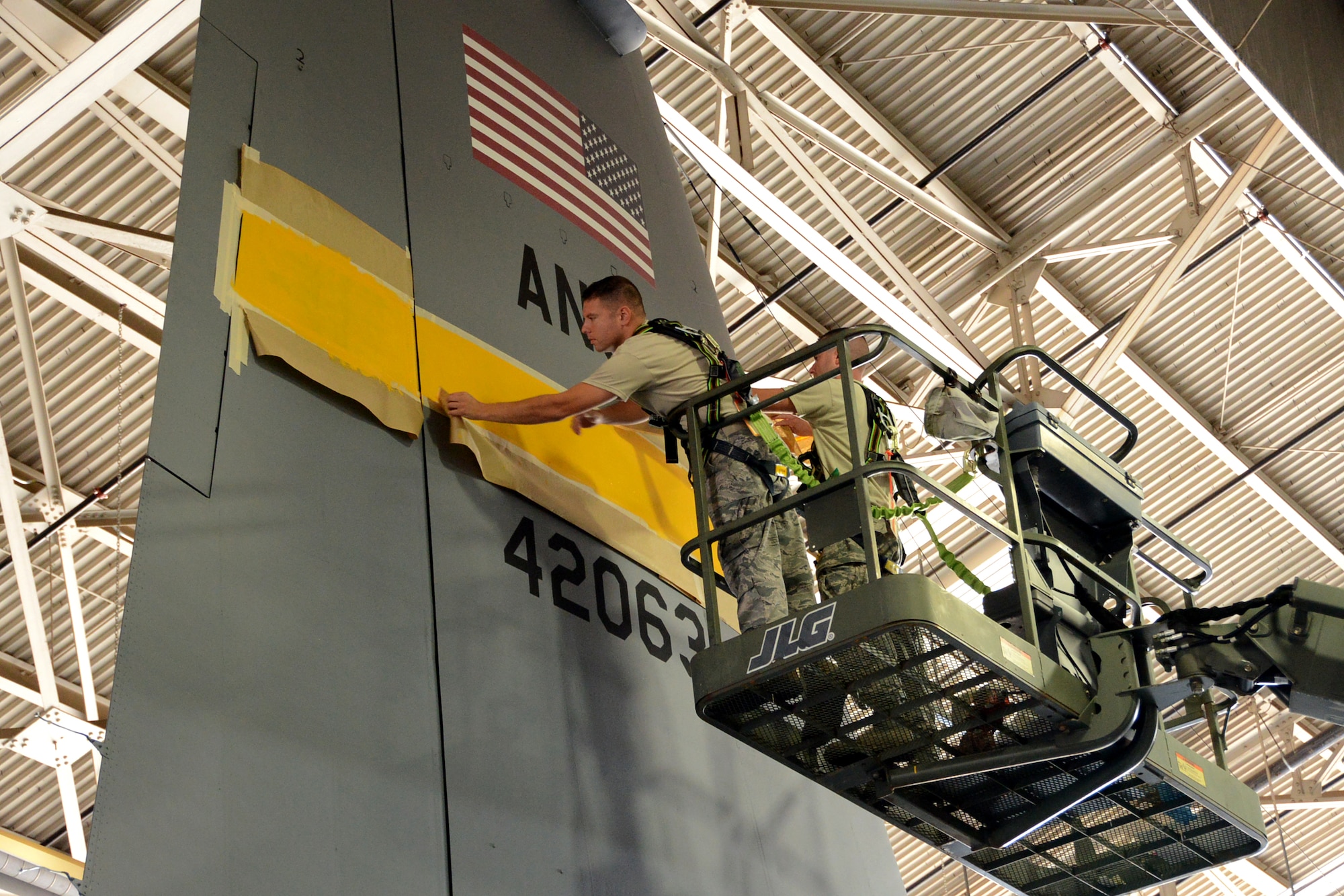 One year after the arrival of the first C-130H Hercules aircraft at Bradley Air National Guard Base, East Granby, Conn., the eighth and final aircraft receives tail paint in the hangar, Friday, October 17, 2014.  The Flying Yankees' acceptance of the final aircraft assigned to the 103rd Airlift Wing Wednesday, October 15, 20104, marks an important milestone in the unit's conversion to the C-130H mission.  (U.S. Air National Guard photo by Master Sgt. Erin McNamara)