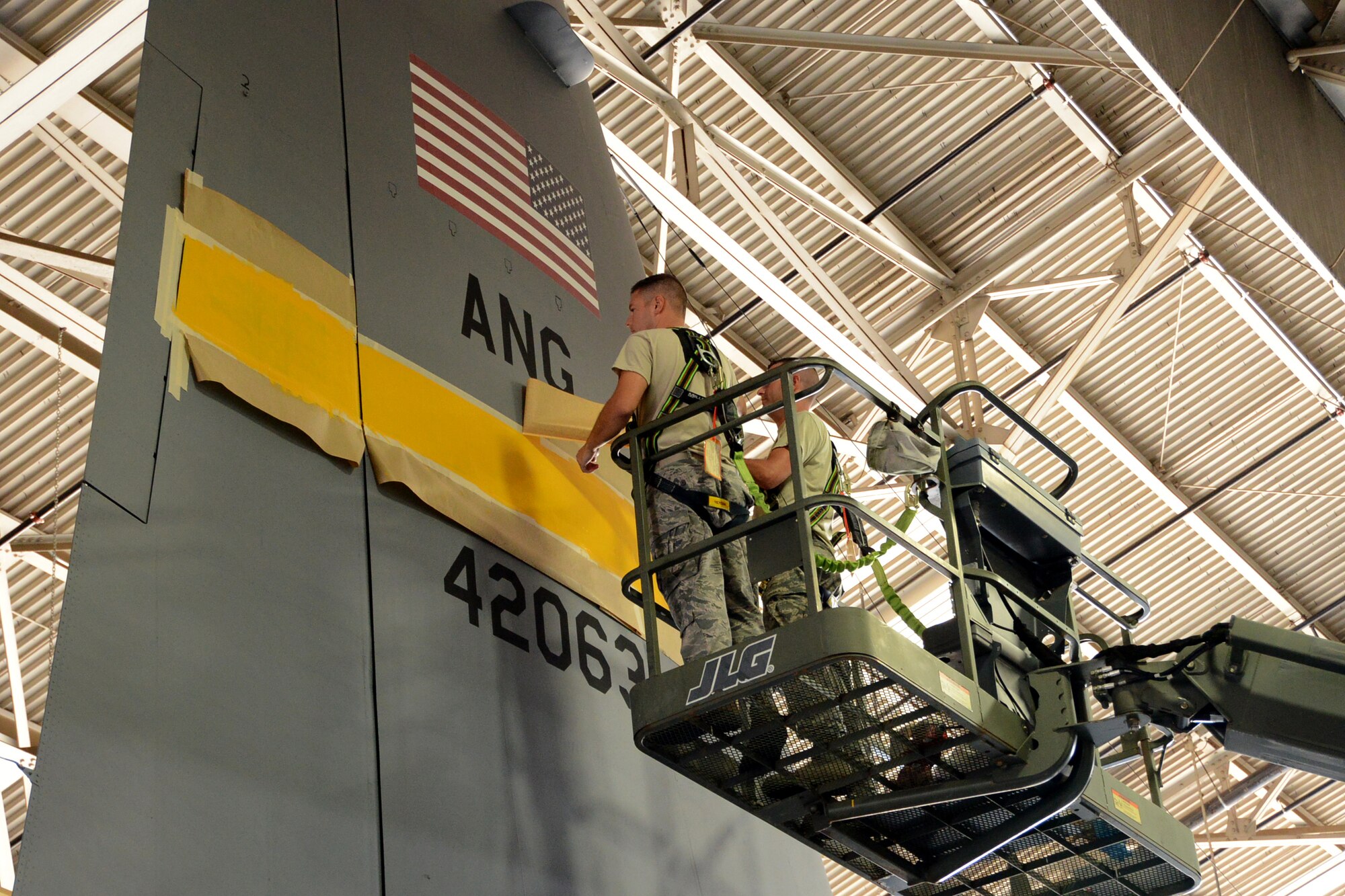 One year after the arrival of the first C-130H Hercules aircraft at Bradley Air National Guard Base, East Granby, Conn., the eighth and final aircraft receives tail paint in the hangar, Friday, October 17, 2014.  The Flying Yankees' acceptance of the final aircraft assigned to the 103rd Airlift Wing Wednesday, October 15, 20104, marks an important milestone in the unit's conversion to the C-130H mission.  (U.S. Air National Guard photo by Master Sgt. Erin McNamara)