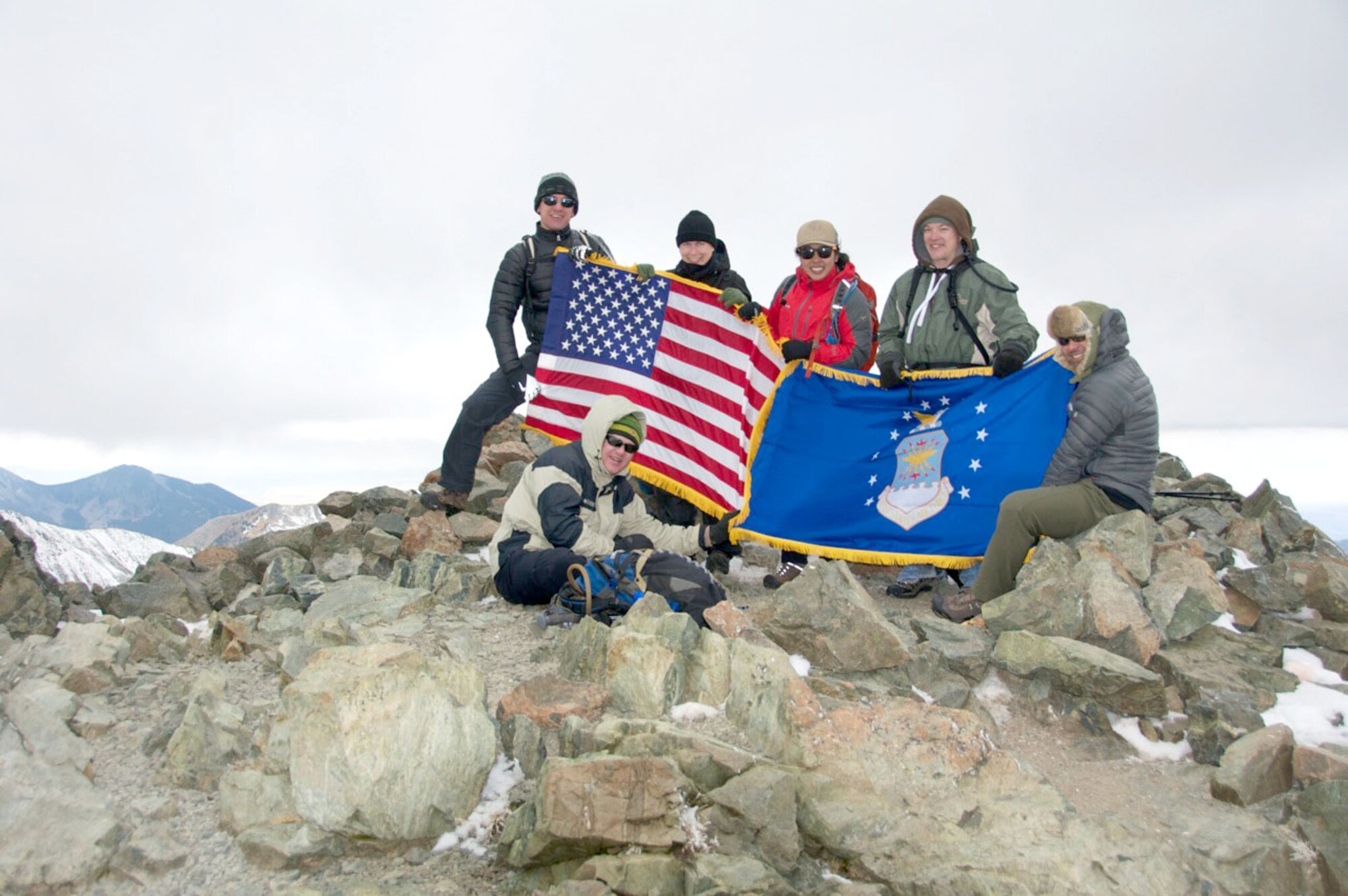 Airmen from Kirtland and Holloman Air Force Bases display the flag following the ascent of Wheeler Peak. The Airmen tackled the peak as part of the 50 Summits Challenge, which aims to promote camaraderie and personal resiliency among Airmen by encouraging teams to carry the Air Force flag to the highest point in all 50 states.  (Courtesy photo)