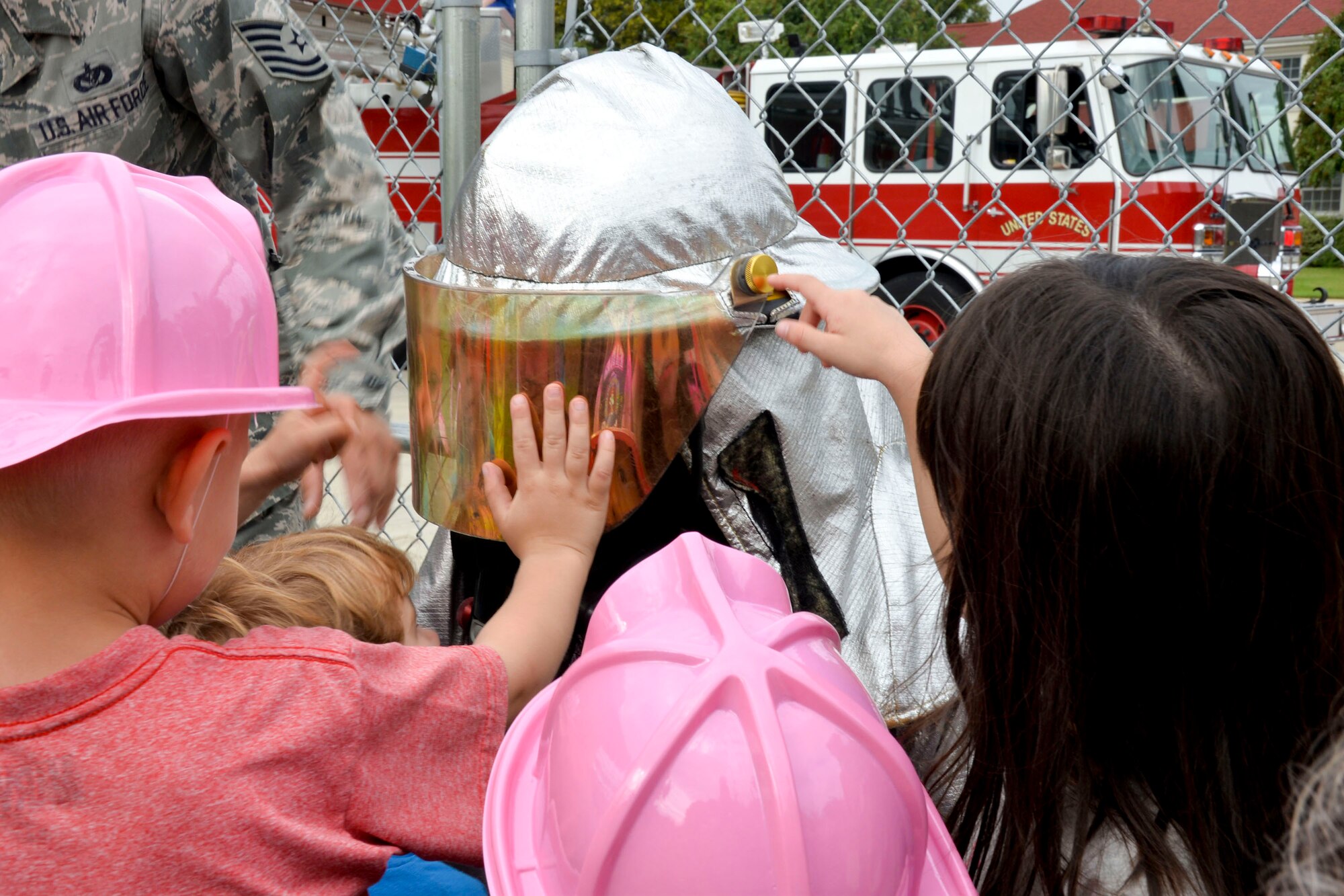Airman 1st Class Juan Rosario, 2nd Civil Engineer Squadron firefighter, demonstrates the use of his personal protection equipment during a visit to the Child Development Center on Barksdale Air Force Base, La., Oct. 8, 2014. Rosario wore a fire proximity suit and told the children at the CDC why it?s important. The suit protects firefighters from thermal radiation and temperatures that can reach up to 2,000 degrees fahrenheit. (U.S. Air Force photo/Airman 1st Class Mozer O. Da Cunha)