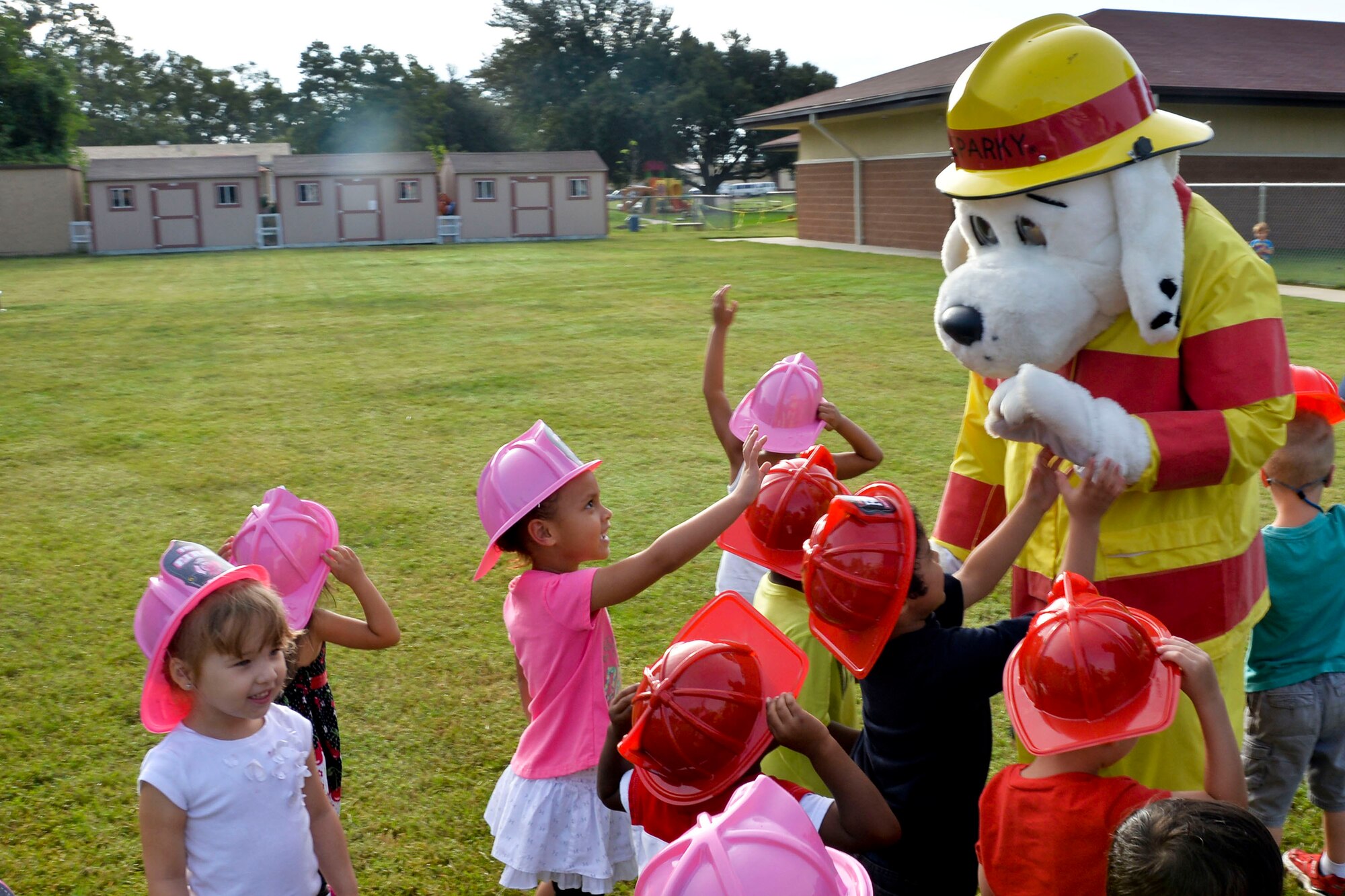 Children gather around Sparky the Fire Dog during a visit to the Child Development Center on Barksdale Air Force Base, La., Oct. 8, 2014. Airmen from the 2nd Civil Engineer Squadron fire department educated children at the CDC about having an escape plan in case of a home fire. (U.S. Air Force photo/Airman 1st Class Mozer O. Da Cunha)