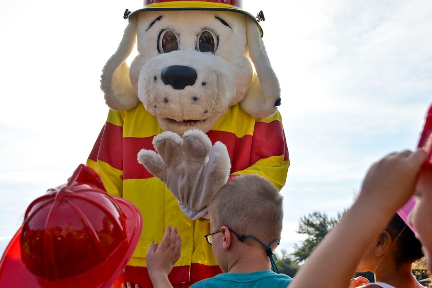 Sparky the Fire Dog interacts with children during National Fire Prevention Week at the Child Development Center on Barksdale Air Force Base, La., Oct. 8, 2014. Fire Prevention Week was established to commemorate the Great Chicago Fire, a tragedy which occurred in 1871. (U.S. Air Force photo/Airman 1st Class Mozer O. Da Cunha)
