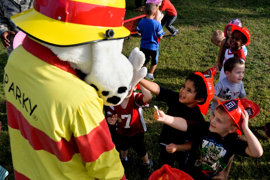Sparky the Fire Dog visits children during National Fire Prevention Week at the Child Development Center on Barksdale Air Force Base, La., Oct. 8, 2014. Fire prevention week aims to increase awareness and educate people on the importance of smoke alarms and their maintenance. (U.S. Air Force photo/Airman 1st Class Mozer O. Da Cunha)